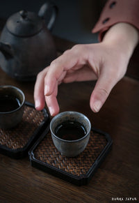 Thumbnail for hand-picking-up-Japanese-tea-cups-with-tea